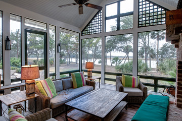 Large luxury screened in porch with view of a river.