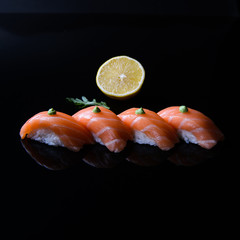 sushi with salmon and lemon on a plate