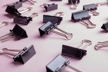 many black clips on pink background, soft focus