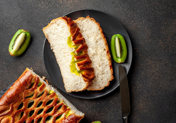tasty pie with kiwi filling ready to eat on a stone background