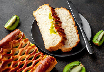 tasty pie with kiwi filling ready to eat on a stone background