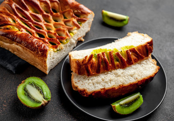tasty pie with kiwi filling ready to eat on a stone background