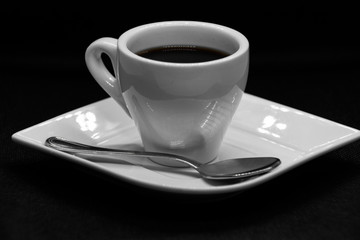Cup of coffee on black background