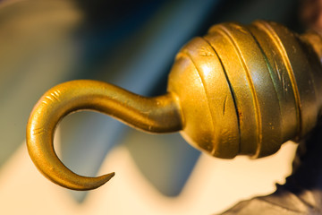 golden color pirate hook toy close up view
