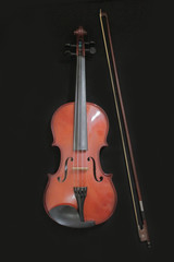 Fototapeta na wymiar violin and bow on black background