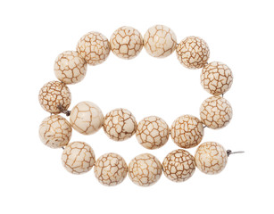 coiled string of beads from cacholong gemstone