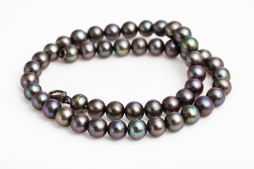 coiled necklace from natural black pearls on white
