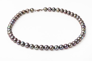 necklace from natural black pearls on white