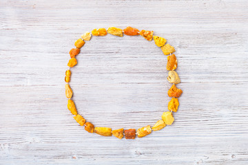 top view of raw amber necklace on gray wood board