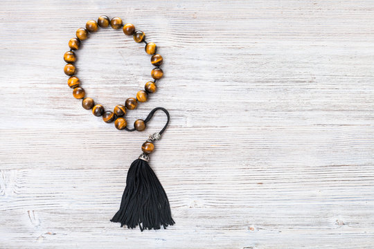 top view of tiger's eye worry beads on gray board