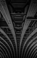 Background or texture detail black and white riveted girder railway bridge