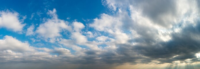 Fantastic clouds against blue sky, panorama