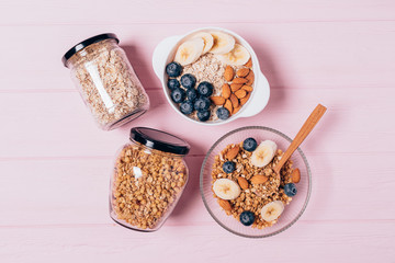 Oatmeal and granola breakfast in bowls and jars