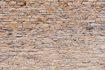 Textural background. Closeup brick stone old aged ancient brown wall