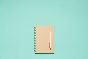 Flat composition notepad with pen on mint desk. Trendy flat lay for bloggers, designers etc.