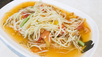 green papaya salad in white plate