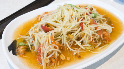 green papaya salad in white plate