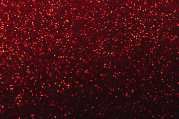 Christmas abstract texture, red sparkles bokeh shining background.