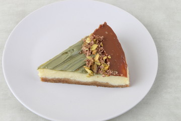 cheesecake with pistachio and nuts - cheese cake isolated on a wooden background