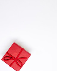 Red gift box on a white background. Red ribbon. Valentine's day gift. Christmas. Isolated. Top view with place for text.