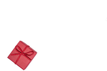 Red gift box on a white background. Red ribbon. Valentine's day gift. Christmas. Isolated. Top view with place for text.