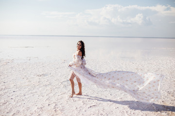 Fototapeta na wymiar Beautiful woman on a pink lake.