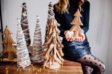 Wooden christmas trees in hands