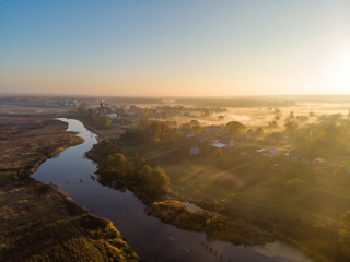 Fototapeta na wymiar Dunilovo village, Ivanovo region, at sunrise in the fall. Shooting from the drone