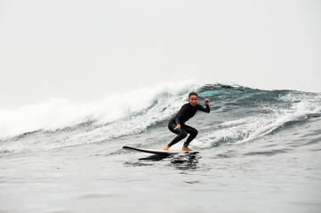 Girl surfing the wave in the ocean
