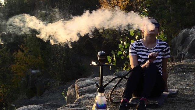 girl guy smokes hookah in the nature