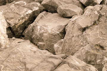 big gray rocks on the shore