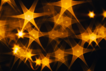 Splash of golden stars on black background.