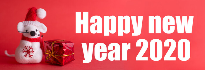 Fototapeta na wymiar Greeting banner symbol of eastern calendar. Cute toy in christmas red hat with gift on red background. Inscription 2020. New year of the white metal (silver) rat.