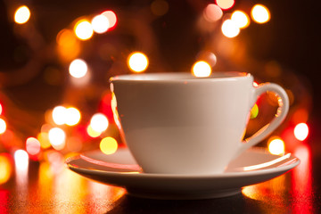 Food, white cup of tea and saucer, lighting lights