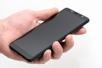 Black smartphone in hand.