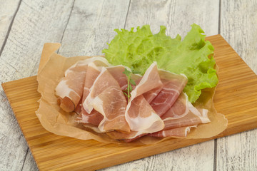 Italian prosciutto pork meat over board