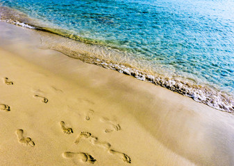 Footprints on the beach in Santo Tomas, Menorca - Spain