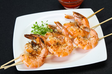 Grilled prawn skewer with sauce