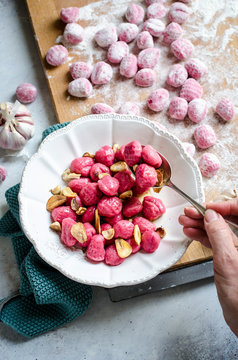 Beetroot Gnocchi In A Bowl With Hazelnuts