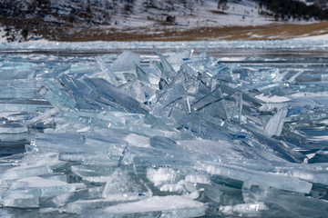 Fototapeta na wymiar Blocks of Ice on lake surface in winter sunny day