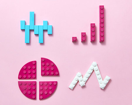 Colored plastic construction block pattern on a pink background. - Powered by Adobe