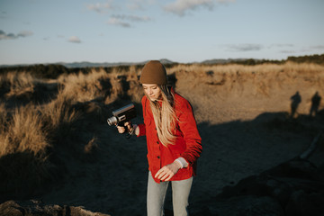 Woman walking with vintage camera