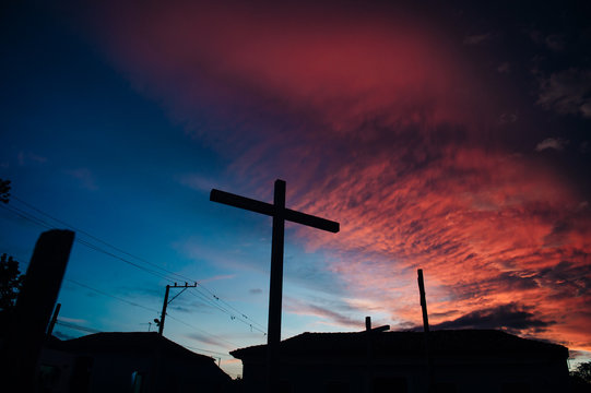Cross against vivid sunset in the Caribbean islands
