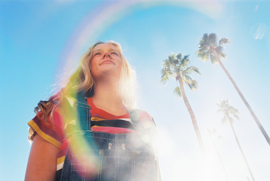 Teen girl with rainbow stripes in bright colors on film