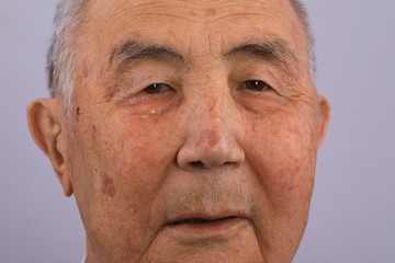 close-up portrait of an old man crying