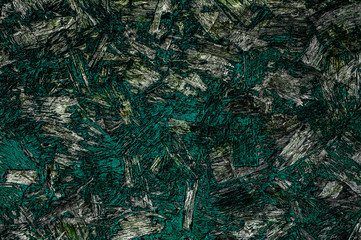 Particle board with teal and green chipped paint