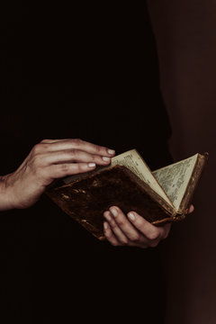 anonymous woman reading a old book