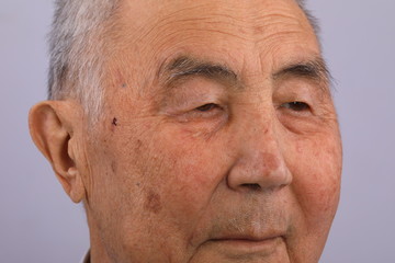 close-up portrait of an old man crying