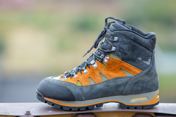 A leather trekking hiking winter boot on blurred background