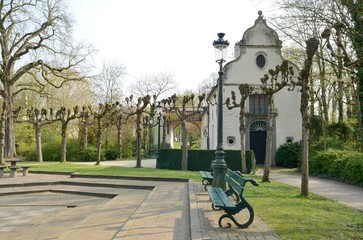 White building in park of Brugge, Belgium